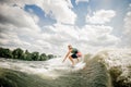 Young man riding on the wakeboard on the lake Royalty Free Stock Photo