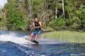 Young man riding wakeboard on summer lake Royalty Free Stock Photo