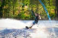 Young man riding wakeboard on summer lake Royalty Free Stock Photo