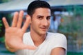 Young Man Rising Hand Making Stop Gesture