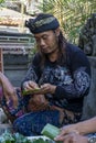 Young man rolling his betel nut in Canggu, Indonesia