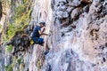 A young man with a rope engaged in the sports of rock climbing on the rock, Extreme sport, Active recreation in nature, A man