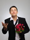 Young man with rose flower and vine bottle Royalty Free Stock Photo