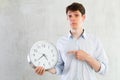 Man with a round big clock in his hands expresses various emotions Royalty Free Stock Photo