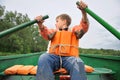 Young man rowing a boat