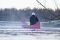 young man rowing canoe in early spring morning. lifestyle. Morning landscape, fog by the morning river and people on the Royalty Free Stock Photo