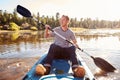 Young Man Rowing Kayak On Lake Royalty Free Stock Photo