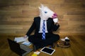 Funny unicorn in a suit and tie smiles and drinks coffee