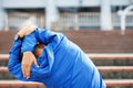 Young man runner stretching for warming up before running or working out on the road. Track and Field Athlete exercise. Royalty Free Stock Photo