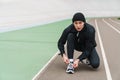 Young man runner tying shoelaces Royalty Free Stock Photo