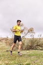 Young man running across the field in a Spartan race Royalty Free Stock Photo