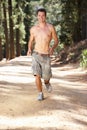 Young man running along country lane Royalty Free Stock Photo