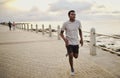 Portrait of a determined african american young athlete runner training outdoors by the seaside Royalty Free Stock Photo