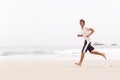 Young Man Running Along Winter Beach Royalty Free Stock Photo