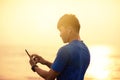 Man running on beach and checking Heart Rate Monitor On smart phone Royalty Free Stock Photo