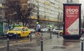 Young man running in the rain on the streets of Bucharest