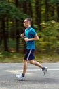 Boy jogging through forest Royalty Free Stock Photo