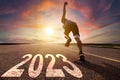 Young man running and sprinting on the road with new year 2023 concept Royalty Free Stock Photo