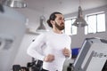 Young Man Running On Treadmill In Gym Royalty Free Stock Photo