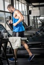 Young man running at treadmill in gym Royalty Free Stock Photo