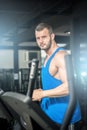 Young man running at treadmill in gym Royalty Free Stock Photo