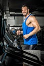 Young man running at treadmill in gym Royalty Free Stock Photo
