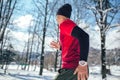 Young man running at winter in park Royalty Free Stock Photo