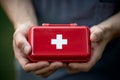 Young man\'s hand firmly grasping a first aid kit