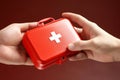 Young man\'s hand firmly grasping a first aid kit