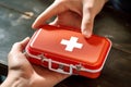 Young man\'s hand gripping a first aid kit