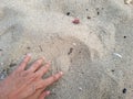 Young man's hands are picking up and playing with sand on the beach Royalty Free Stock Photo