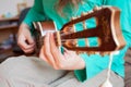 Young man`s hands playing an acoustic guitar ukulele at the home. A man playing ukulele in close up view Royalty Free Stock Photo
