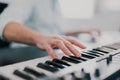 Young man`s hands playing keyboard piano, composing music , music record concep, art, song composition, melody