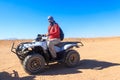 Young man in safari trip through egyptian desert driving ATV. Quad bikes safari in the desert near Hurghada, Egypt Royalty Free Stock Photo