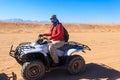 Young man in safari trip through egyptian desert driving ATV. Quad bikes safari in the desert near Hurghada, Egypt Royalty Free Stock Photo