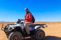 Young man in safari trip through egyptian desert driving ATV. Quad bikes safari in the desert near Hurghada, Egypt Royalty Free Stock Photo