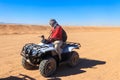 Young man in safari trip through egyptian desert driving ATV. Quad bikes safari in the desert near Hurghada, Egypt Royalty Free Stock Photo