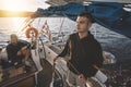 Young man at the sailboat helm