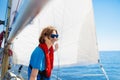 Young man sailing. Teenager boy on sea sail boat.