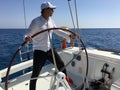 Young man sailing yacht steering wheel vacation Royalty Free Stock Photo