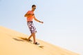 Young man sand boarding