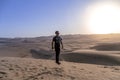 young man on sand in a desert near Huacachina, Ica region, Peru. The sunset desert view Royalty Free Stock Photo