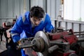 Young man sanding or iron at industrial factory, mechanic working job while polish metal.