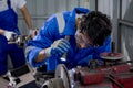 Young man sanding or iron at industrial factory, mechanic working job while polish metal.