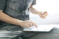 Young man sat in the living room on sofa  , using his tablet pc and holding credit card her online To buy product in the internet Royalty Free Stock Photo