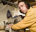 Young Man Sawing Some Wood Royalty Free Stock Photo