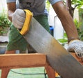 young man sawing wood at home use for diy working and home maintenance in holiday and male activities Royalty Free Stock Photo
