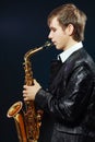 Young man with saxophone Royalty Free Stock Photo