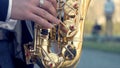 Young man with saxophone outside near the old painted wall. Young expressive musician playing the saxophone. Art and Royalty Free Stock Photo