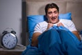 Young man scared in bed Royalty Free Stock Photo